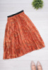 Жіноча помаранчева спідниця в принт