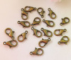 Замок -лобстер. Размер - 12 мм. Цвет - бронза. Упаковка - 5 шт.