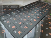 Наклейка на клавиатуру, «винил» черный, оранжевые/белые знаки.